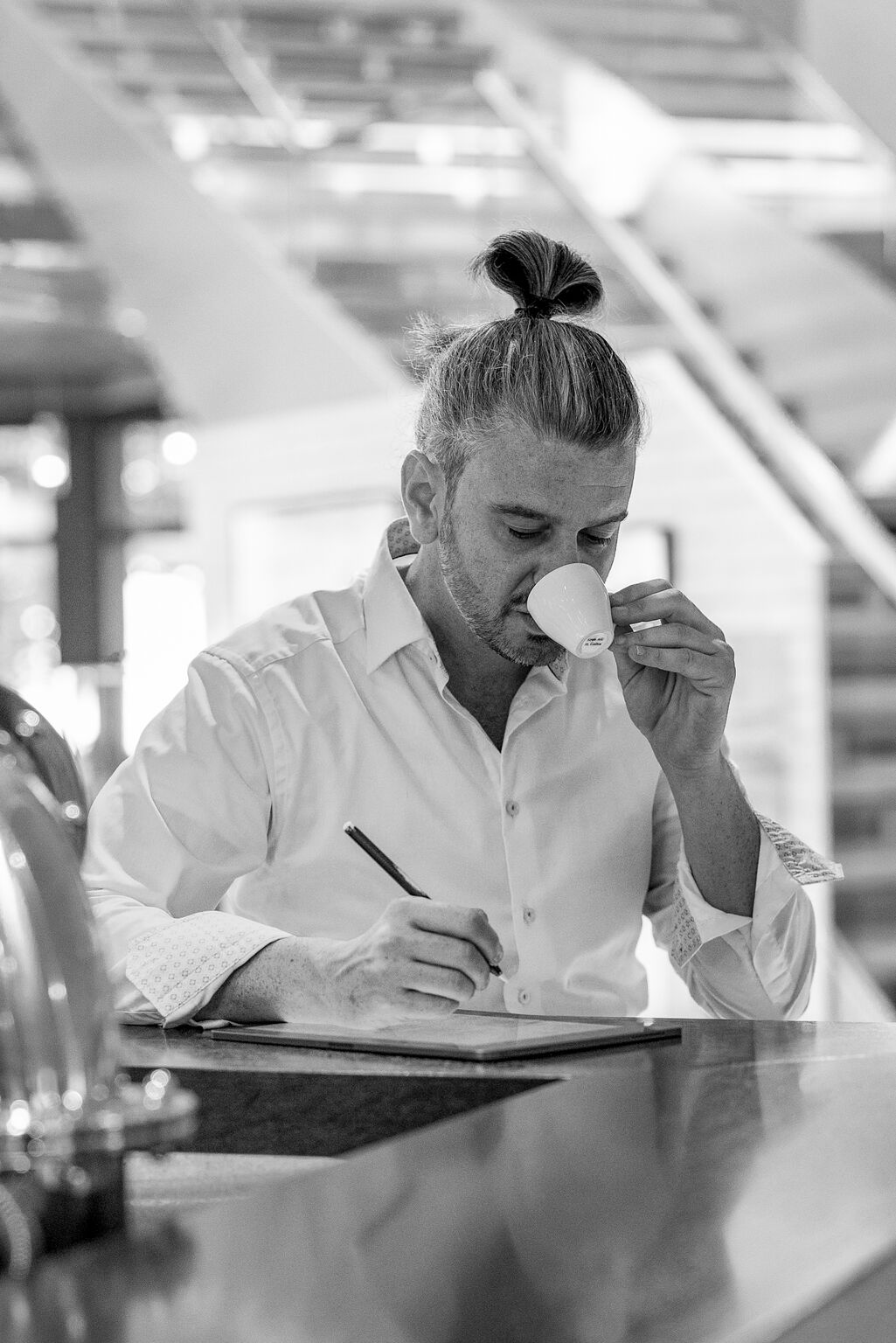 Donato Blandolino drinking an espresso and taking notes.